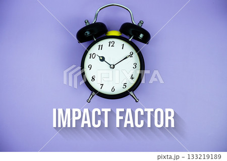 Impact Factor text and alarm clock on purple background 133219189