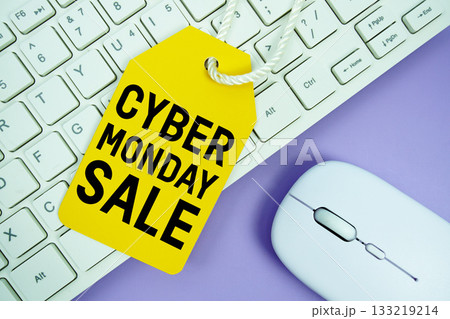 Price tag with text "Cyber Monday Sale" and white keyboard and wireless mouse on yellow background 133219214