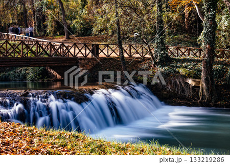 Scenic view of a wooden bridge over a waterfall in Monasterio de Piedra, Spain Scenic view of a wooden bridge over a waterfall in Monasterio de Piedra, Spain 133219286