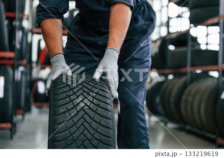 Ready to change the tire. Man is in the tire fitting car service 133219619