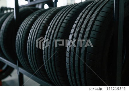 In the right order. New tires are placed on the storage rack in the car workshop 133219843
