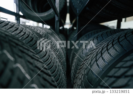 In the right order. New tires are placed on the storage rack in the car workshop 133219851