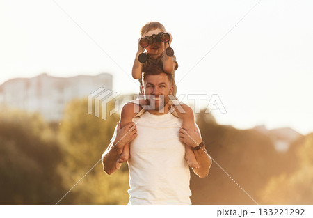 Binocular in hands. Father and son are together on the field 133221292