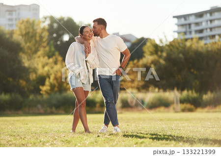 Front view. Lovely couple are having a walk on the field 133221399