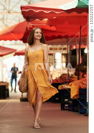 Cheerful, feeling happy. Young woman is on the vegetable market or bazaar 133222357