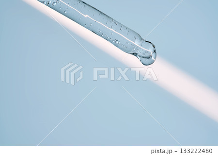 A serum pipette with lots of bubbles on a blue background. A serum pipette with lots of bubbles on a blue background. 133222480