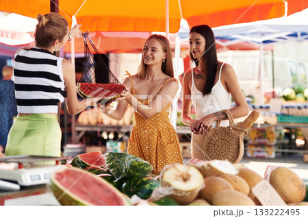 Red fresh watermelon. Two women are together on the marker or bazaar 133222495