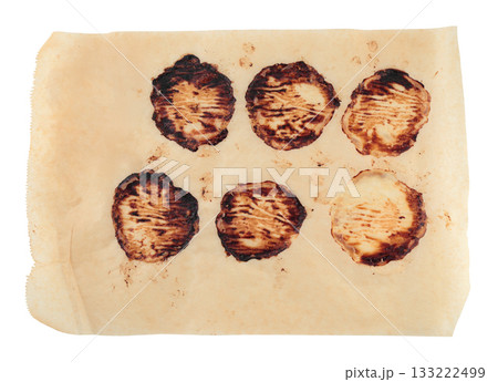 Kitchen parchment sheet with baked meat patty stains, isolated on transparent background. Realistic cooking texture for food design, recipe mockups, and culinary projects Kitchen parchment sheet with baked meat patty stains, isolated on transparent background. Realistic cooking texture for food design, recipe mockups, and culinary projects 133222499