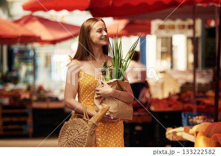 Spring onion, front view. Young woman is on the vegetable market or bazaar Spring onion, front view. Young woman is on the vegetable market or bazaar 133222582