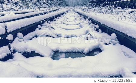 Icy winter setting showcasing unique tracks and bright blue shades 133222683