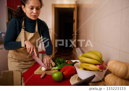 Woman Preparing Fresh Vegetables in Kitchen With Fruit Bowl and Bananas Woman Preparing Fresh Vegetables in Kitchen With Fruit Bowl and Bananas 133223153