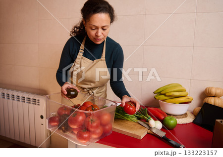 Home Kitchen Tomato Prep With Fresh Produce And Bananas In Apron 133223157