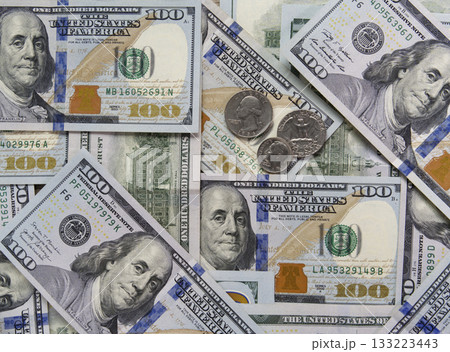 Hundred-dollar bills and some coins as background. Business concept. Hundred-dollar bills and some coins as background. Business concept. 133223443