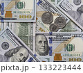 Hundred-dollar bills and some coins as background. 133223444