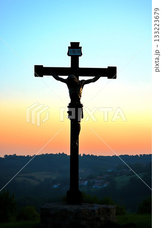 Cross with the name Jesus Christ on it is standing in a field Cross with the name Jesus Christ on it is standing in a field 133223679