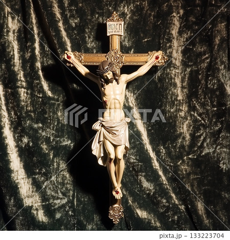 Crucifix is displayed on a green velvet background Crucifix is displayed on a green velvet background 133223704