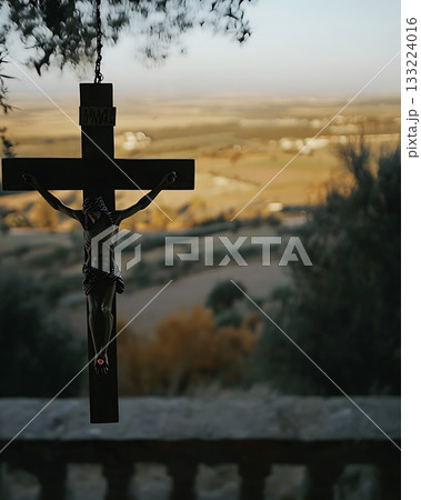 Crucifix is hanging from a tree 133224016