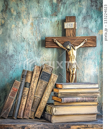 Cross is on top of a stack of books 133224023