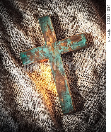 Cross is on a cloth with a light shining on it Cross is on a cloth with a light shining on it 133224054