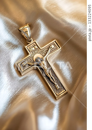 Gold cross with a man in the middle of it 133224095