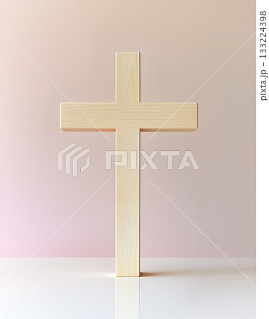 Wooden cross is standing upright on a white table 133224398