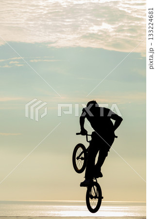 Freestyle cyclist practicing street BMX 133224681