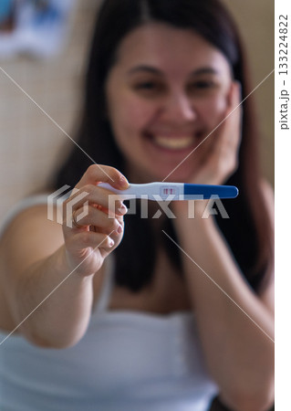 Surprised Woman with Positive Pregnancy Test Surprised Woman with Positive Pregnancy Test 133224822