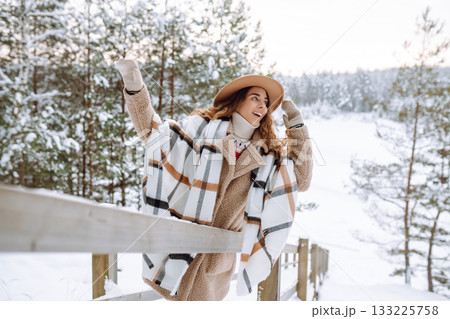 Woman traveler in a hat with a backpack on a wooden ladder. Active lifestyle. Travel concept. Woman traveler in a hat with a backpack on a wooden ladder. Active lifestyle. Travel concept. 133225758