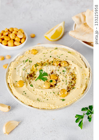 Lupin hummus with herbs and olive oil on white textured background. Vegan protein-rich dip concept. Lupin hummus with herbs and olive oil on white textured background. Vegan protein-rich dip concept. 133225958