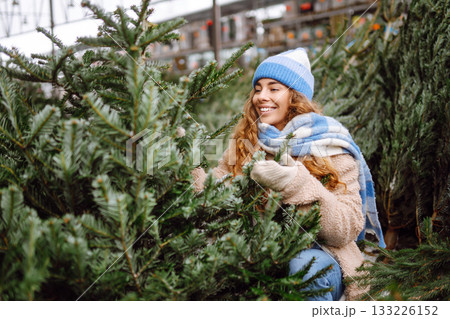 A young woman feels Christmas is approaching. Concept of holidays, traditions. 133226152