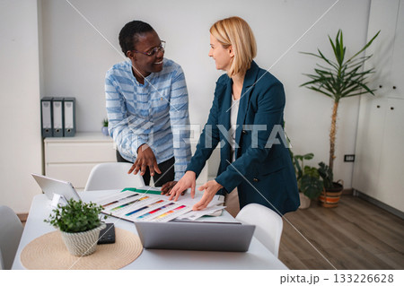 Diverse women collaborating on design project choosing colors Diverse women collaborating on design project choosing colors 133226628