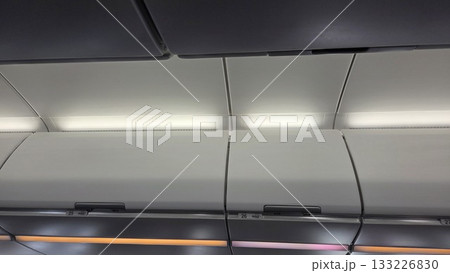 Interior of airplane cabin ceiling and overhead storage bins Interior of airplane cabin ceiling and overhead storage bins 133226830