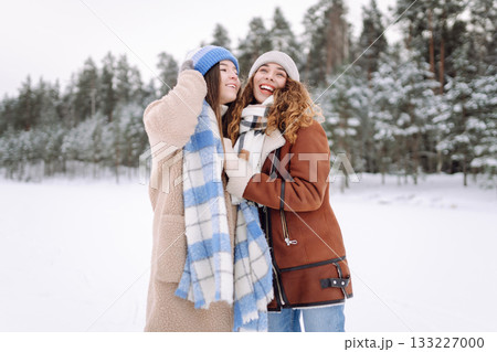 Happy friends having fun playing in winter park. Friends communicate and enjoying nature. 133227000
