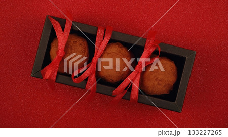 Chocolate Truffles in Elegant Box With Red Accents Create a Delightful Gift for Special Occasions 133227265