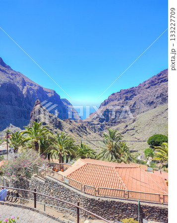 Experience the breathtaking beauty of a stunning mountain landscape beneath a brilliant azure sky 133227709