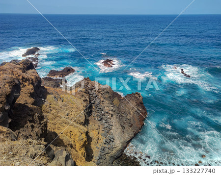 A Stunning and Beautiful Rock Formation Standing Majestically by the Ocean Waves Nearby A Stunning and Beautiful Rock Formation Standing Majestically by the Ocean Waves Nearby 133227740