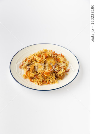 Chicken pilaf with basmati rice and carrots on plate, studio food photo on white 133228196