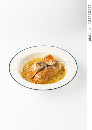 Stuffed meat rolls with carrot filling in savory gravy on a white background 133228197