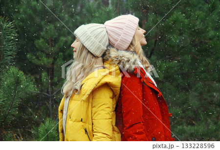 Happy smiling women friends having fun, celebration, joyful girlfriends together on Christmas tree Happy smiling women friends having fun, celebration, joyful girlfriends together on Christmas tree 133228596