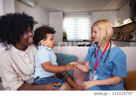 Caring doctor listening to family concerns Caring doctor listening to family concerns 133228797