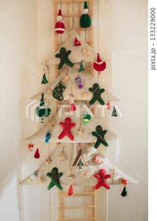 A handmade textile Christmas tree with felt gingerbread cookies A handmade textile Christmas tree with felt gingerbread cookies 133229000
