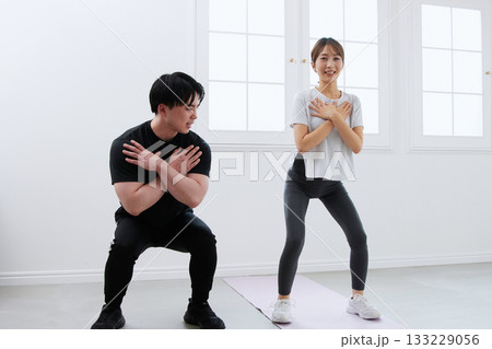 パーソナルトレーナーにトレーニングを受ける若い女性 パーソナルトレーナーにトレーニングを受ける若い女性 133229056