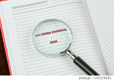 A magnifying glass reveals the bold phrase unlimited potential on a planner page marked 2026, symbolizing hope, ambition, and a vision for a prosperous future ahead A magnifying glass reveals the bold phrase unlimited potential on a planner page marked 2026, symbolizing hope, ambition, and a vision for a prosperous future ahead 133229281