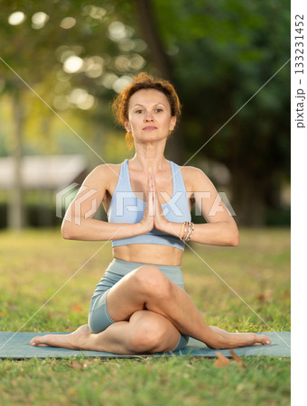 Adult woman doing yoga in cow head pose Adult woman doing yoga in cow head pose 133231452