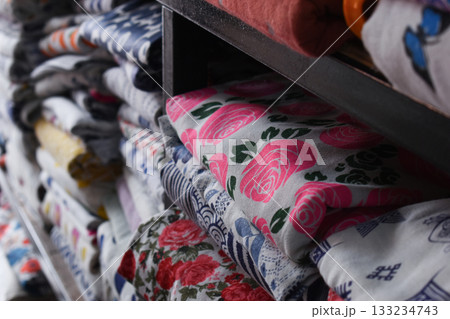 heap of colorful cloth on shelf for sale in store heap of colorful cloth on shelf for sale in store 133234743