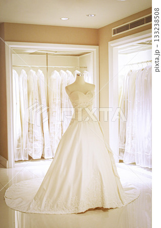 Elegant Bridal Gown on Display in Luxury Boutique Showroom with Long Train, Lace and Ivory White 133238508
