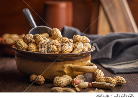 Peanuts in shell. Groundnuts in bowl on wooden table. Peanuts in shell. Groundnuts in bowl on wooden table. 133239220
