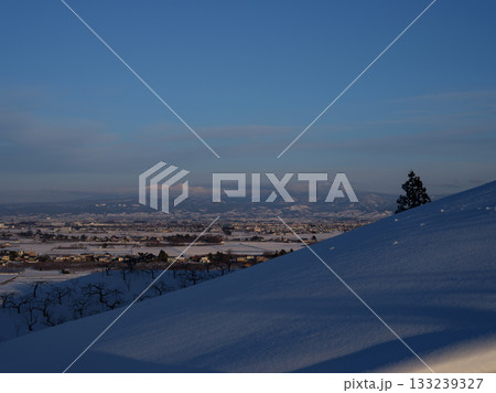 雪山から眺望する弘前市と遠くの八甲田連峰 雪山から眺望する弘前市と遠くの八甲田連峰 133239327