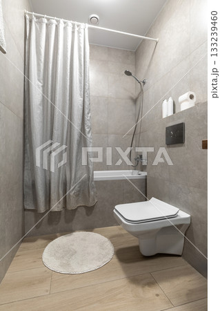 Minimalist Bathroom with Shower Curtain and Wall Hung Toilet 133239460