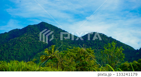 beautiful view of mountains with white clouds and clear blue sky in the background 133241179